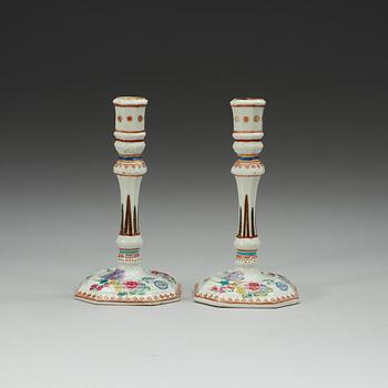 A pair of famille rose candle sticks, Qing dynasty, Qianlong (1736-95).