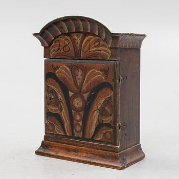 A pianted wall cabinet, dated 1812..