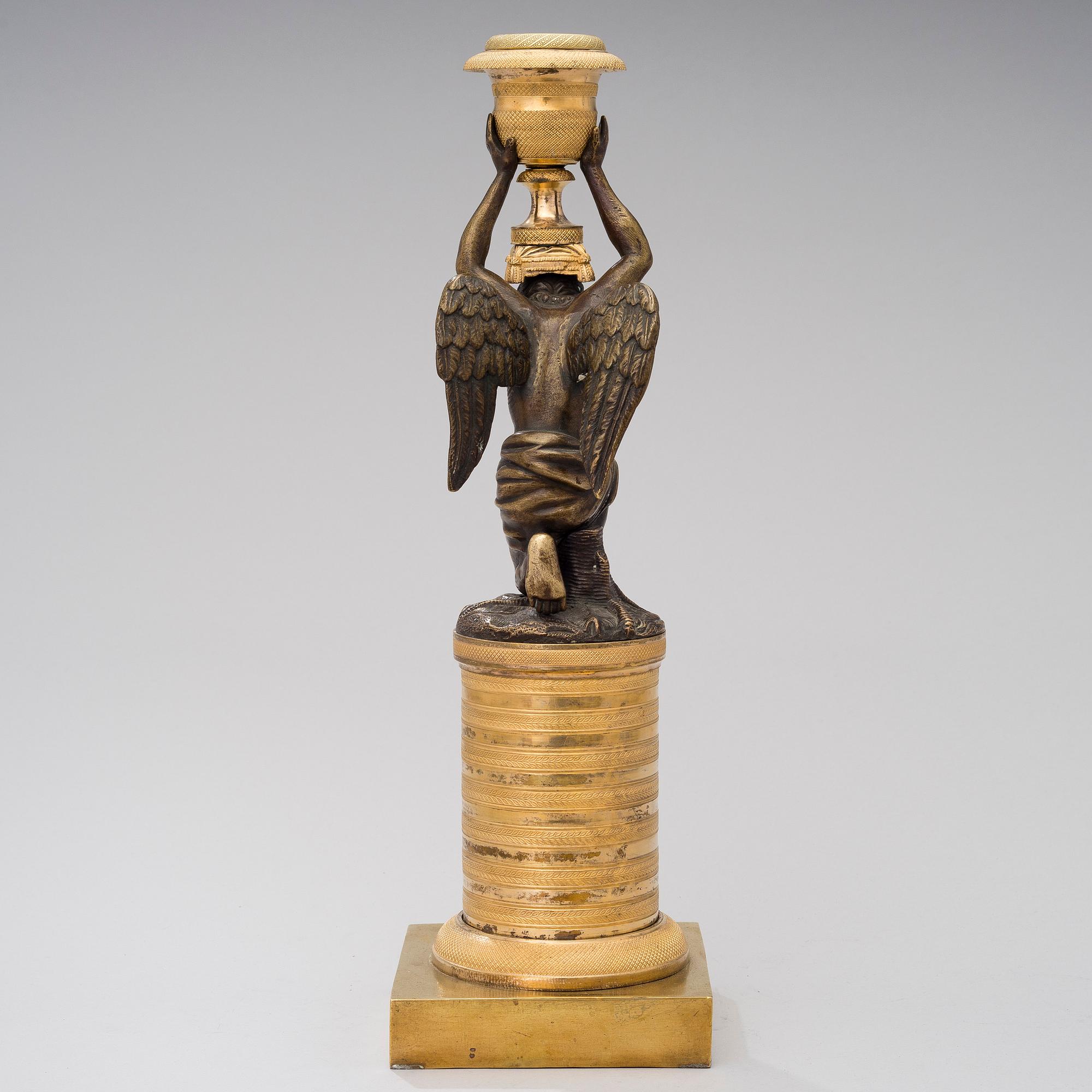 A ORMOLU CANDLESTICK, bronze and gilded bronze, empire early 19th century.