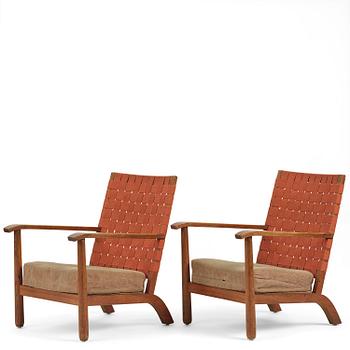 250. Axel Einar Hjorth, a pair of stained pine "Väddö" easy chairs, Nordiska Kompaniet, Sweden, 1930s-40s.