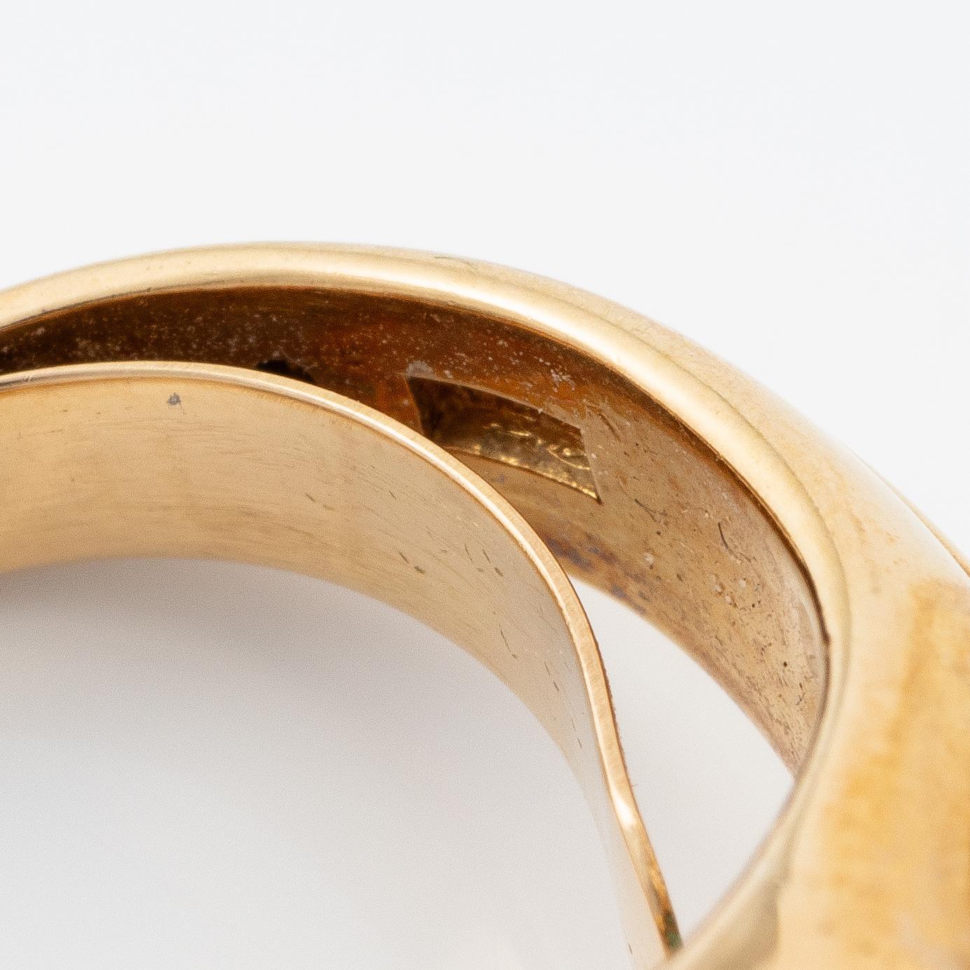 A W.A. Bolin ring in 18K gold with a turquoise and round brilliant- and eight-cut diamonds.