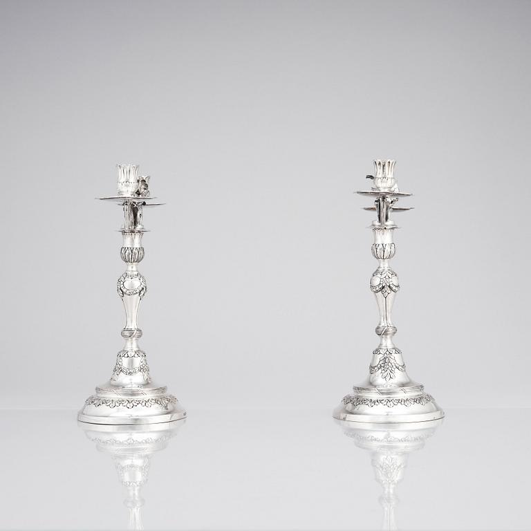 A pair of Swedish 18 century silver candelabras, mark of Lars Åkerblom Gävle 1775, arms by Christian Kullberg.