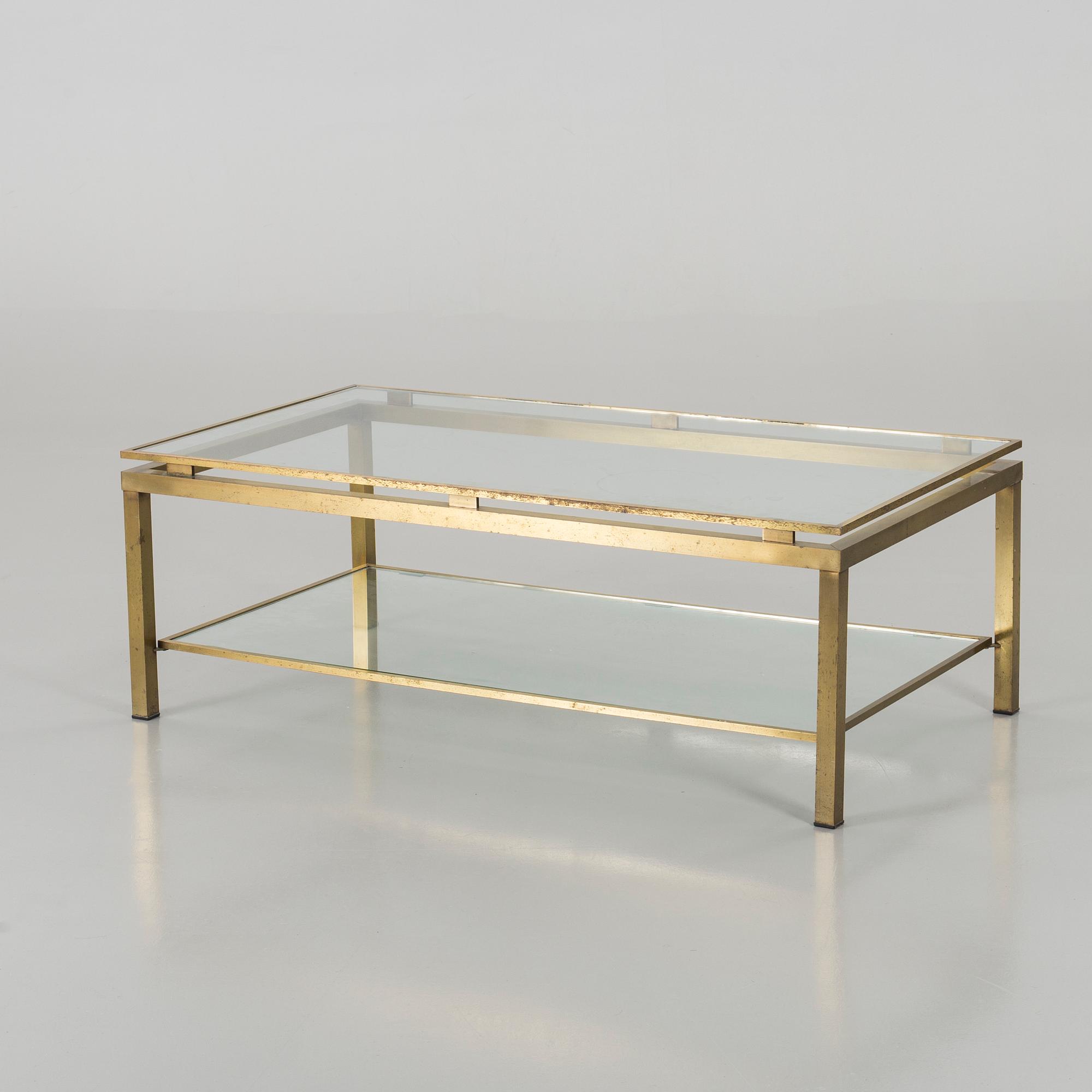 A BRASS GLASS TOP COFFEE TABLE.