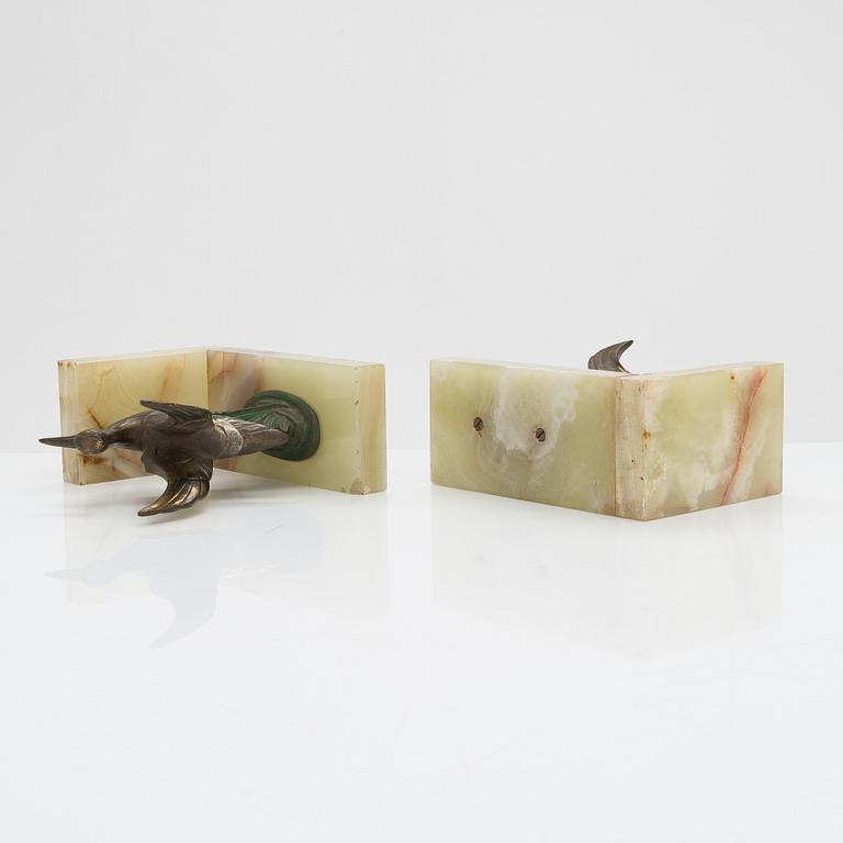 A pair of alabaster and  patinated metal Art Deco bookends from the first half of the 20th Century.