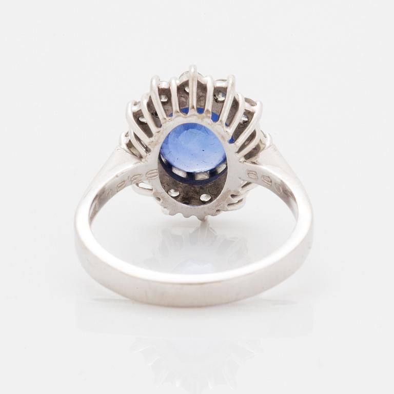 Oval faceted sapphire and brilliant-cut diamond ring.