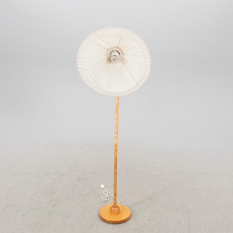 A Markslöjd 21st century wooden floor lamp.