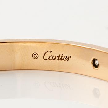 A Cartier "Love" bracelet in 18K rose gold with round brilliant-cut diamonds.