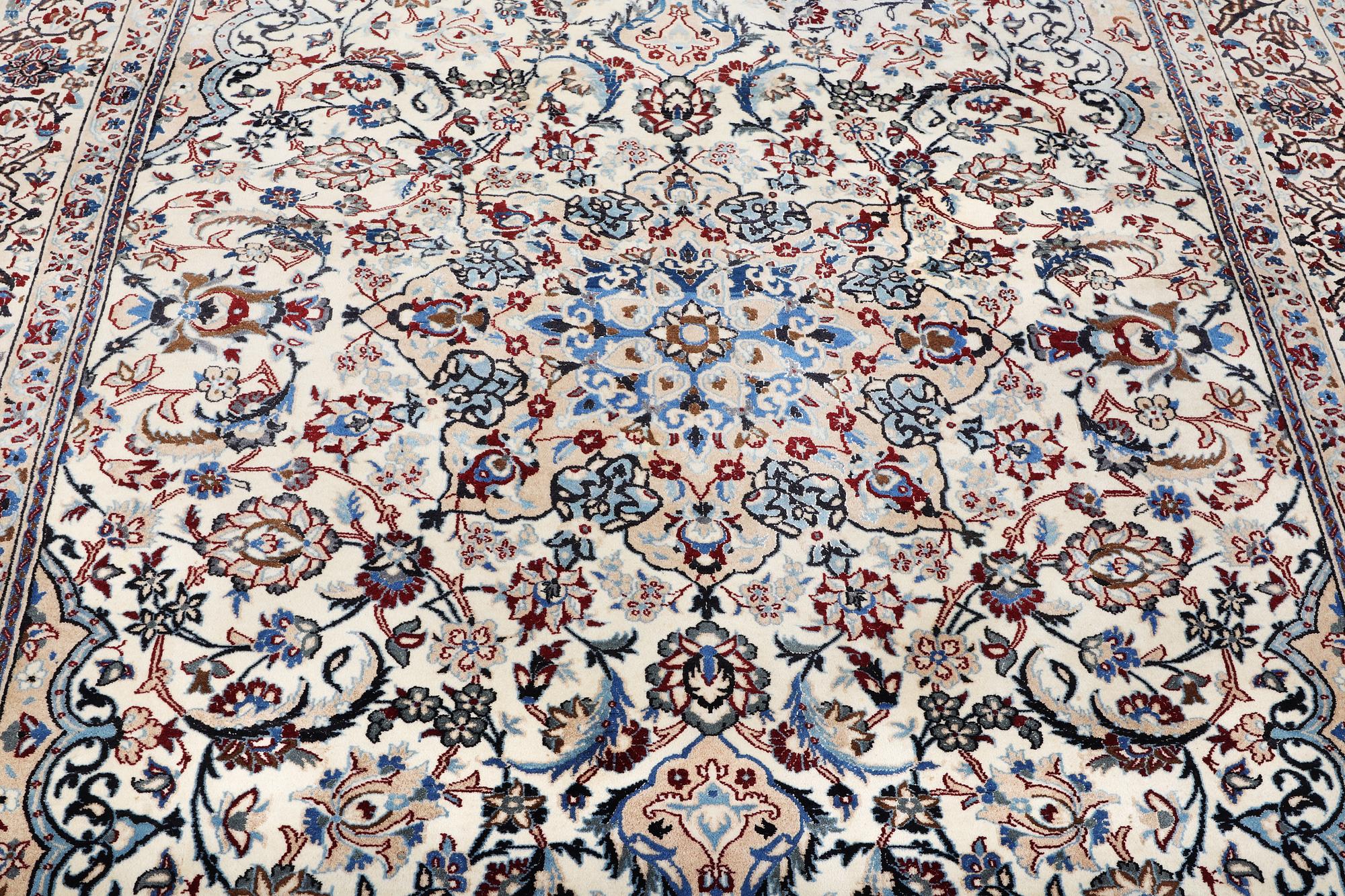 A Nain carpet, part silk, 9 laa, c. 318 x 209 cm.