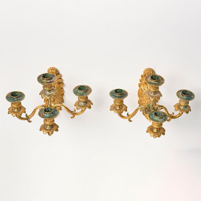 A pair of late Empire ormolu four-branch wall lights, circa 1840.