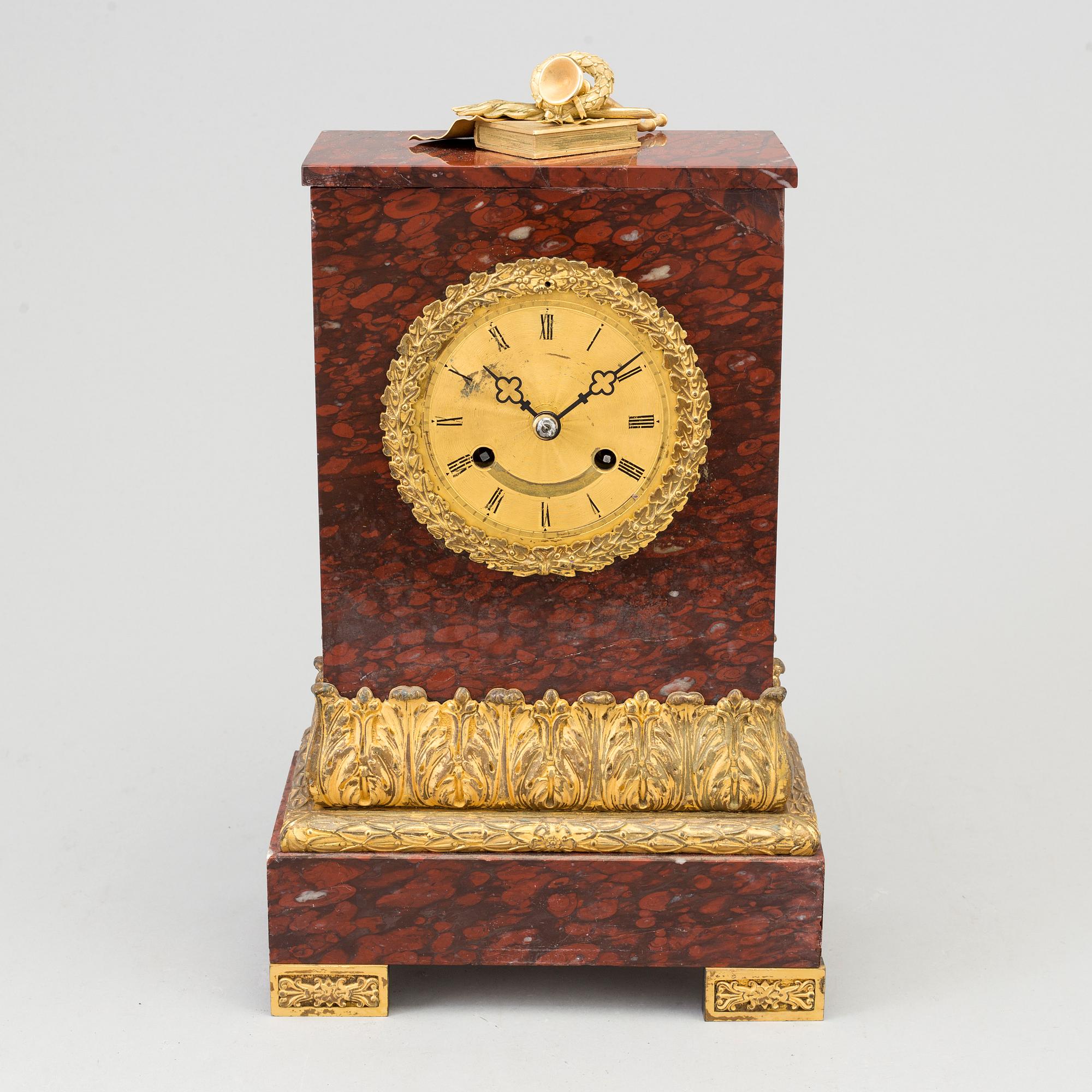 AN EMPIRE ORMOLU AND MARBLE MANTEL CLOCK, first half of the 19th century.