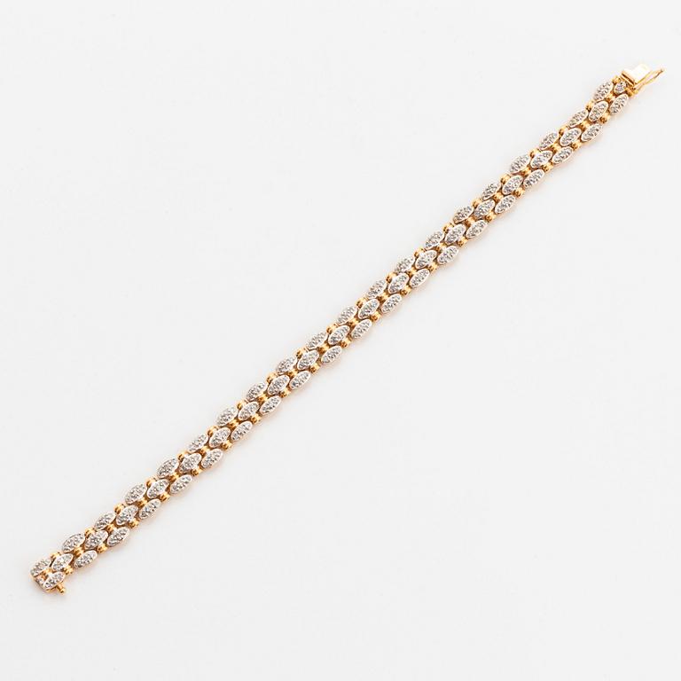 An 18K gold and white gold bracelet set with round brilliant-cut diamonds.