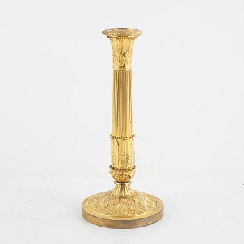 A French Empire gilt-bronze candlestick, early 19th century,