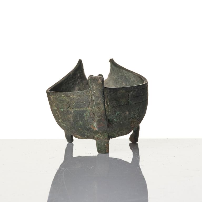 A Chinese brushpot, Qing dynasty, circa 1900. An archaistic bronze ewer and a silvered South East Asian bowl with stand.