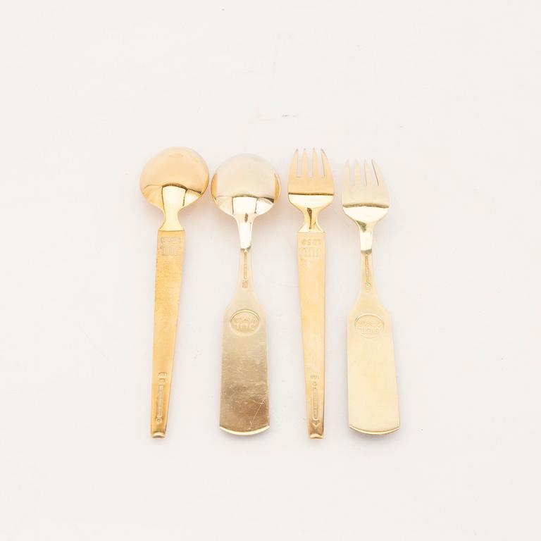 A fanish 20th century set of 24 pcs of gildes silver cutlery with enamel mark of A Michelsen  weight 1112 grams.