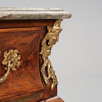 A Swedish early rococo parquetry, ormolu-mounted and marble commode, presumably by S. Pasch or J. Wulf , ca. 1740.