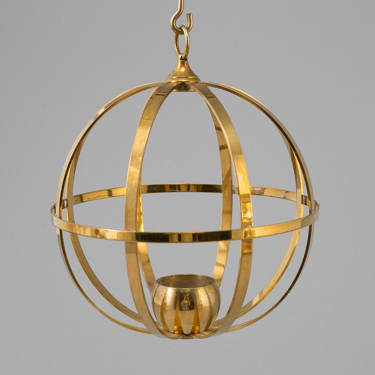 A brass pendulum candle model X10, by Skultuna.