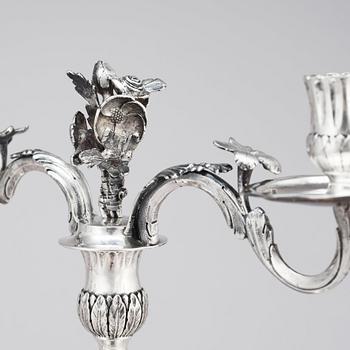 A pair of Swedish 18 century silver candelabras, mark of Lars Åkerblom Gävle 1775, arms by Christian Kullberg.