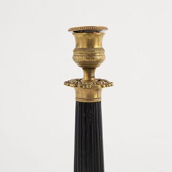 A pair of brass candle sticks, late empire, mid 19th century.