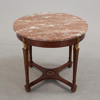 An empire-style table, early 20th century.