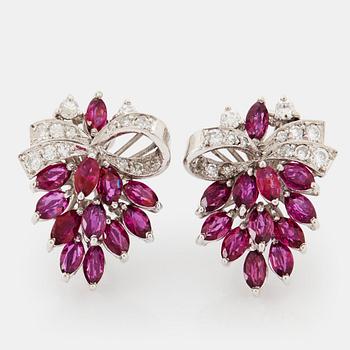 1039. A pair of 18K white gold earrings set with faceted rubies and round brilliant- and eight-cut diamonds.