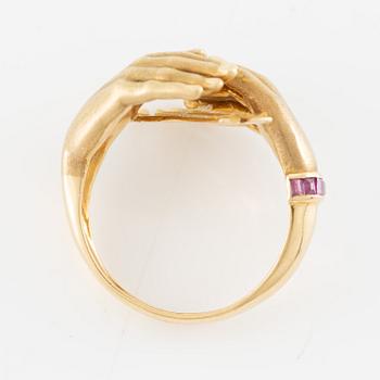 Ring, 18K gold in the form of hands, set with carré-cut rubies.