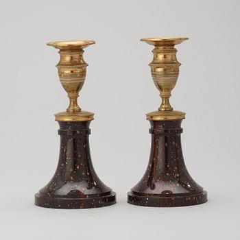 A pair of late Gustavian circa 1800 porphyry and gilt bronze candlesticks.