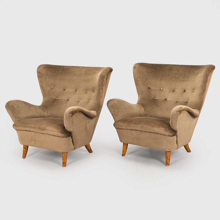 A pair of mid-20th century armchairs.