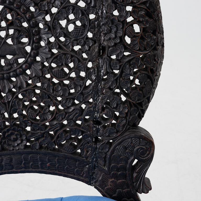 A carved 'blackwood' armchair.  bombay presidency circa 1880.