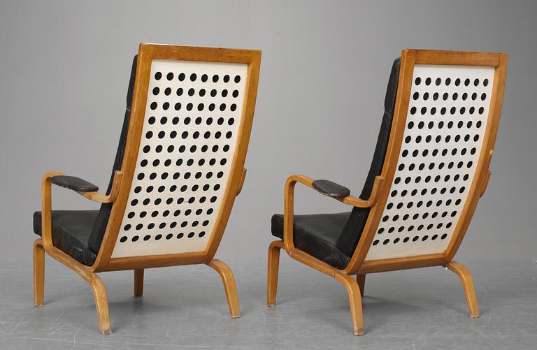 A pair of Carl-Axel Acking armchairs in beech and white lacquered plywood, upholstered in black leather by DUX ca1949-51.