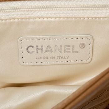 CHANEL, a beige quilted leather flapbag.