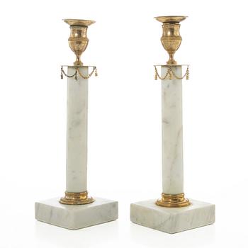 A pair of late Gustavian gilt brass and marble candlesticks, circa 1800.