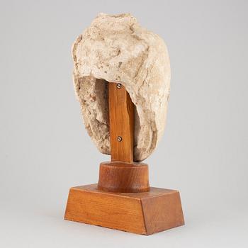 A South East Asian stone mass sculpture of a head, presumably modern manufacturing.