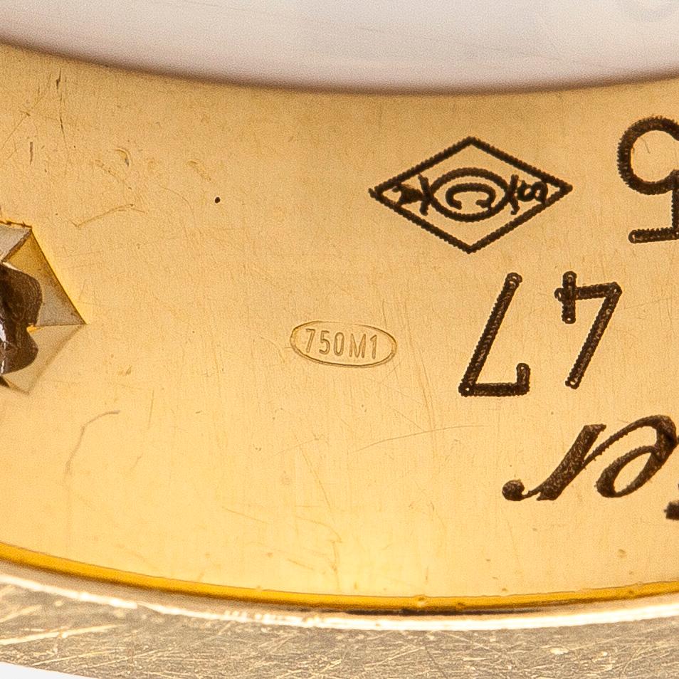 Cartier, an 18K gold 'Love' ring with three brilliant-cut diamonds.