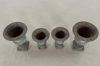 Two pairs of cast iron garden urns.