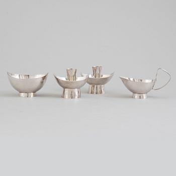 A pair of silver candlesticks, a silver bowl and a silver creamer, Öhmans Eftr, P Aug, Lycksele.