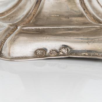 A silver sugar tong by Johan Warjus, and a silver salt cellar by Adolf Sper, St Petersburg 1856 and 1849.