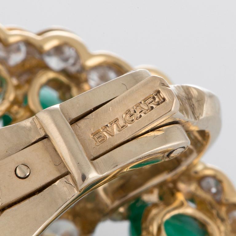 A pair of Bulgari earrings set with cabochon-cut emeralds and round brilliant-cut diamonds.