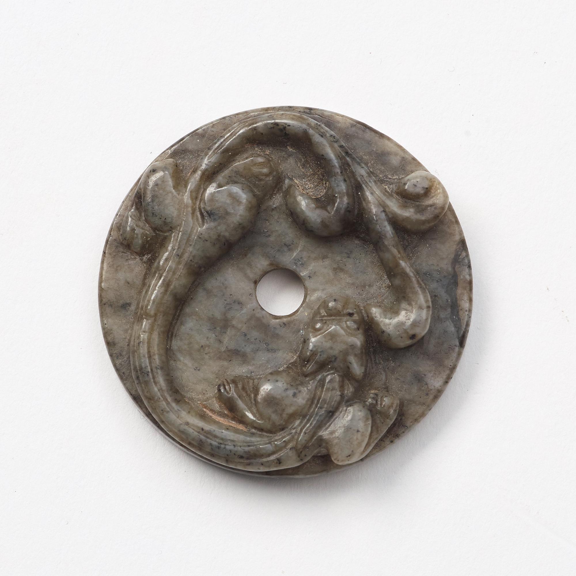 A group of three archaistic Chinese stone bi discs and two pendants.