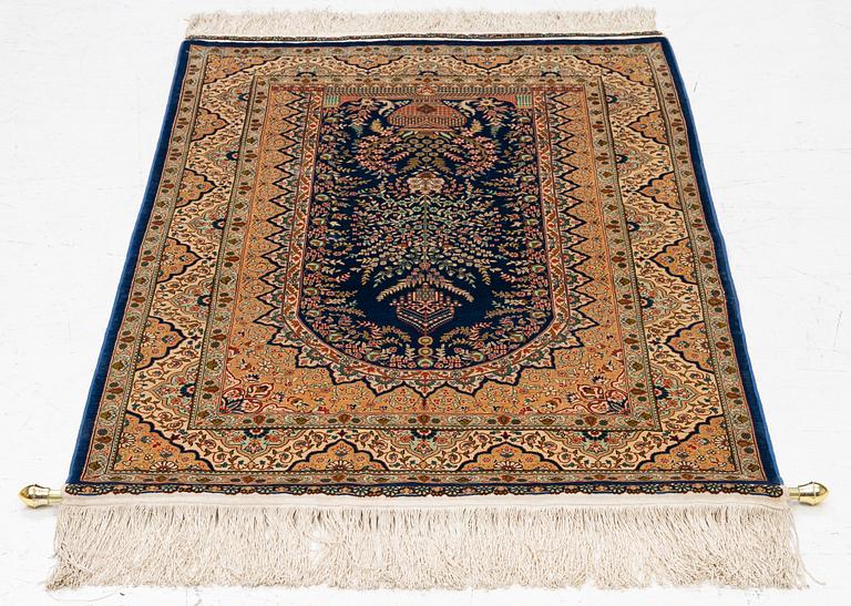 A semi-antique silk Hereke rug, West Anatolia, signed c. 107 x 72 cm.