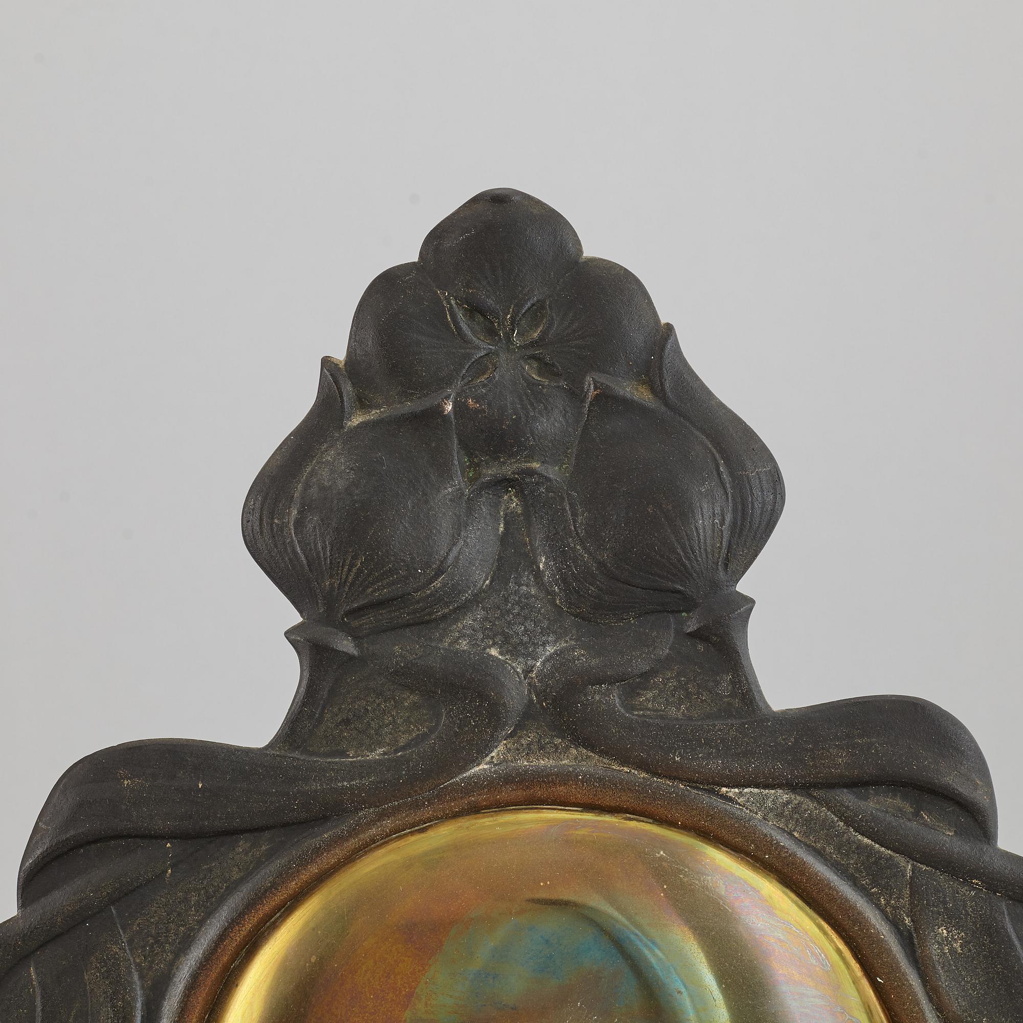 A pair of bronze and brass wall sconces from the early 20th century.