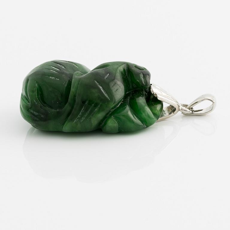 Pendant with carved green stone.