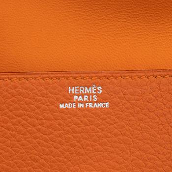 Hermès, a orange leather 'Dogon' wallet, 1998.