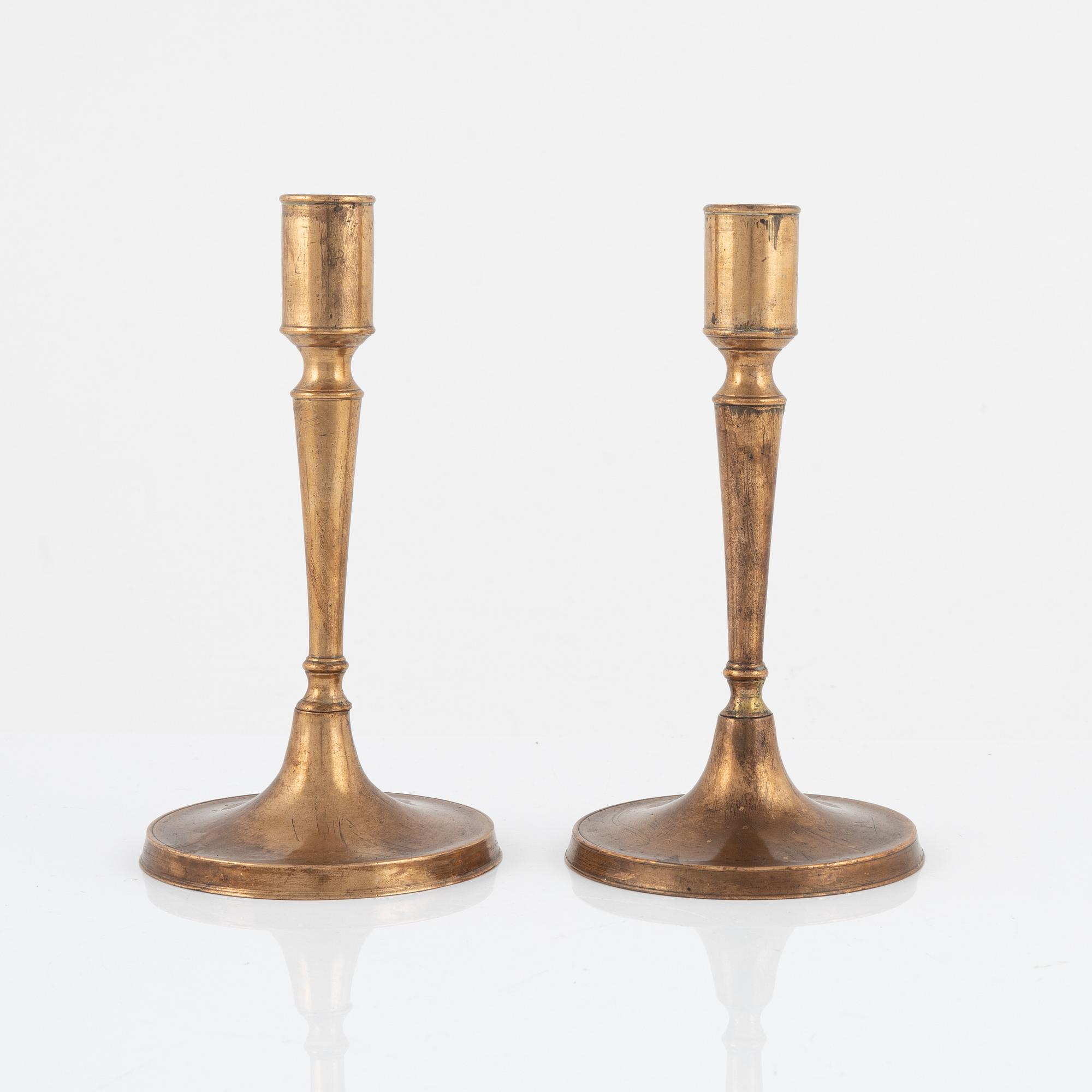 A pair of bronze candlesticks, 18th Century.