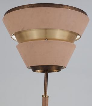 A beige lacquered floor lamp, with brass and artificial leather, possibly a scetch by Alvar Aalto, 1950's.