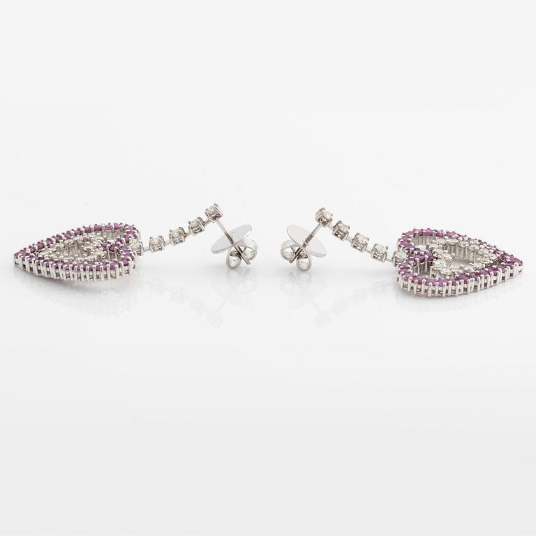 A pair of 18K gold earrings with round brilliant-cut diamonds and pink sapphires.