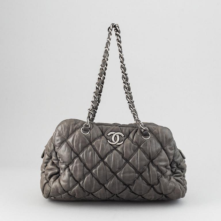 Chanel, a grey leather bag.