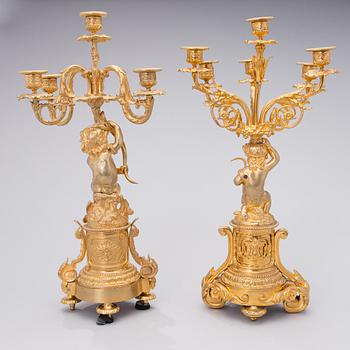 Two similar mid 19th century candelabra in gilt bronze,