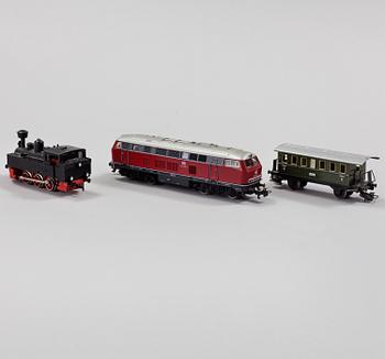 A model train set with locomotives, wagons, rail H0, Danish village houses, tunnel, mountain and more.