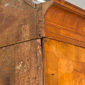 A Swedish walnut-veneered rococo cabinet in the manner of C. Linning, latter half of the 18th Century.