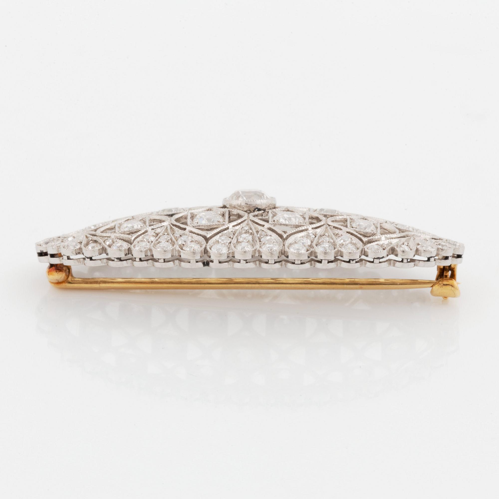 A platinum and gold brooch set with old-cut diamonds.